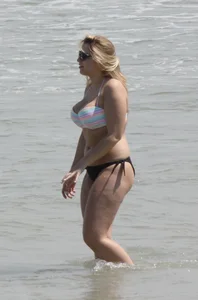 Big boobed thick blonde on the beach in a bikini