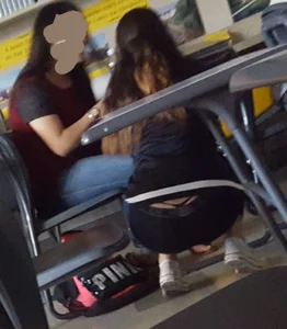 College girl revealing tiny thong while bending over in classroom