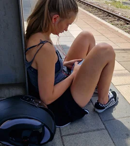 A Hot Candid Girl in Mini-Shorts And Sneakers Sitting on the Floor at the Railway Station Creepshots Gallery