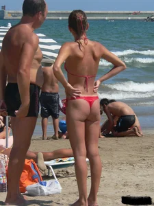 A bunch of hot babes on the beach in thong bikinis