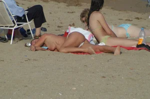 Topless girls on a beach in Barcelona