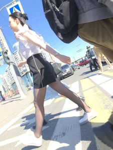 Skinny candid teen wearing shorts and black pantyhose crossing the street