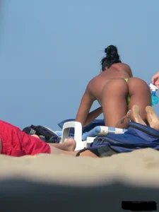 Hot ass topless beach girl with great tits lets her little brother oil up her ass in thong bikini