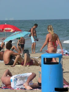 Sexy mom and daughter in red thongs at the beach
