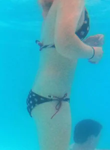 Underwater shots of a bikini teen swimming in the pool