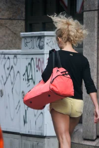 Blonde looking sexy walking in short yellow shorts