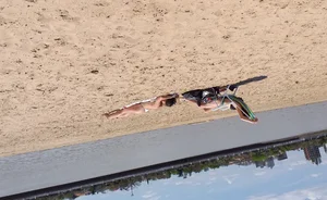 Girl laying out getting sun in a white thong bikini