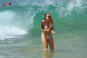Sexy beach babe in see through wet white thong bikini