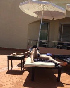 Blonde laying out in a blue bikini with a sexy body