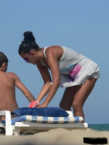 Hot ass topless beach girl with great tits lets her little brother oil up her ass in thong bikini