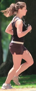 Cute girl running in short shorts