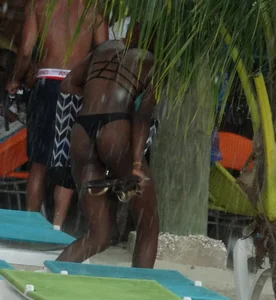 Candid black family, milf and teens on the beach in bikinis