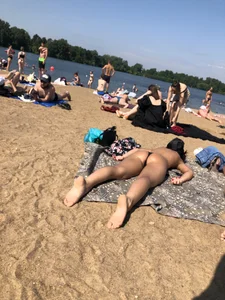 Gorgeous milf rubbing sun lotion in her skin at the beach, with a couple of her milf friends