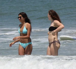 Brunette and redhead on the beach in bikinis looking sexy