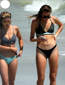 2 sexy babes on the beach in thong bikinis