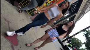 Sexy braless babe showing pokies while out walking with her friend