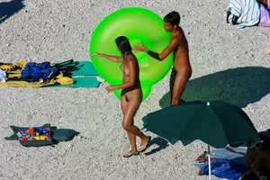 FKK Nudists playing in the water with floater