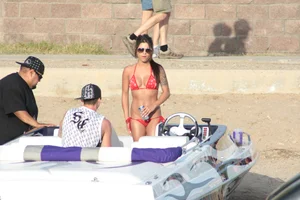 Brunette on a boat in red thong bikini with a tight little ass