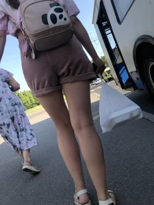 Young Girl in Sandals and Shorts in a Public Bus