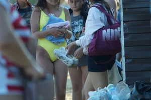Sexy Girl in One-Piece Yellow Swimsuit Walking on the Beach Candid Photo Gallery