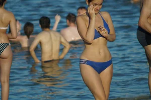 Girl with Wide Pelvis and Thin Waist in Blue Swimsuit Walking on Sand by the Water Beach Creepshots