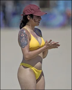 Sexy tattooed beach brunette with a great ass in yellow thong bikini