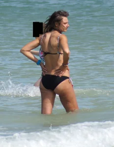 Older mature beach lady in a black bikini