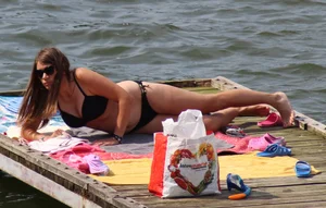 Thick babe with big boobs in a black bikini