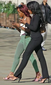 Slim ebony teens in leggings posing in the sun