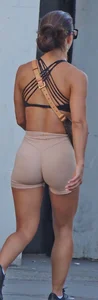 Tanned fitness woman showing off her toned physique & amazing butt
