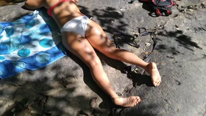 Sexy bikini ass laying out on the rocks up close