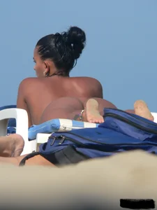 Hot ass topless beach girl with great tits lets her little brother oil up her ass in thong bikini
