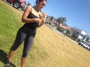 Hot brunette babe in leggings walking her dog with a nice ass and some cleavage