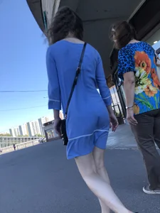 Girl in a Blue Dress With Pale Legs Walking Down the Street - Strong Wind Making Her Panty Line Visible