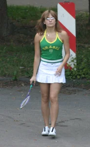 Pretty girl playing tennis in a skirt and walking in jeans