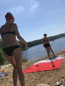 Skinny Girl in Swimsuit Lying on the Lake Beacg Topless and Bending Over