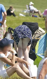 Pale milf in a skirt giving a peek at her green panties