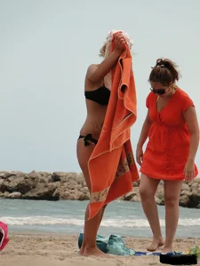 Tattooed blonde with big tits topless and in thong