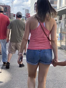 Bunch of girls in various outfits at a Cardinals baseball game