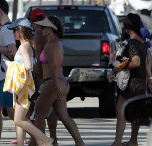 Latina milfs on a beach in Florida in thong bikinis with big booties