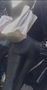 Milf shows off her shapely ass in her leather pants at the market
