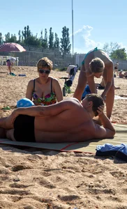 Sexy blonde milf on the beach in blue thong bikini and showing nice camel toe