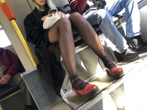 Amazing legs in black pantyhose in a public bus