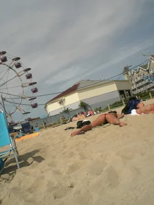 Milf laying out on a beach in Maine in her little thong