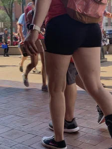 Bunch of girls in various outfits at a Cardinals baseball game