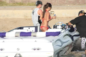 Brunette on a boat in red thong bikini with a tight little ass