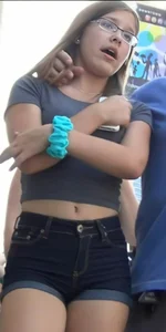 Cute candid teen wearing a crop top and denim shorts