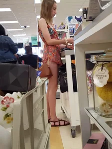 Tall skinny girl wearing sandals and a short dress a tthe store