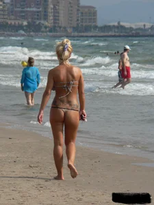 Tattooed blonde with big tits topless and in thong
