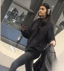 Tight curvy latina at airport pulls up pants